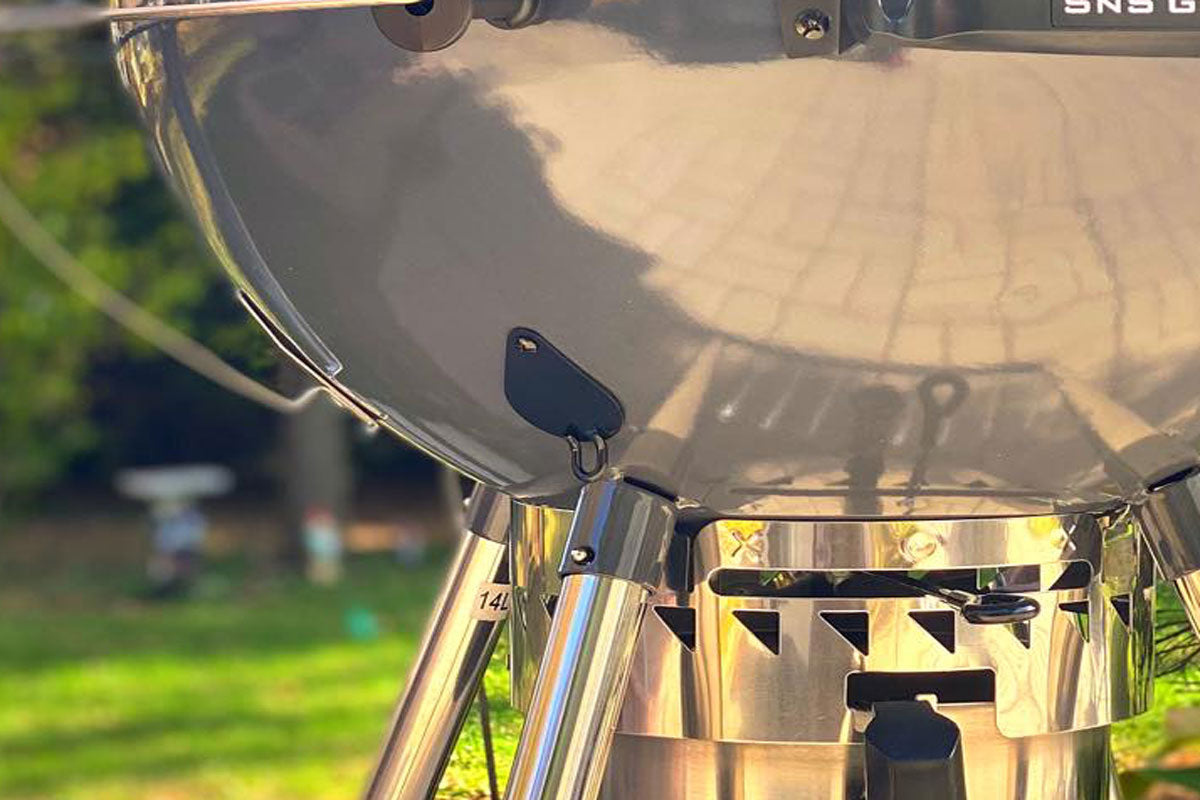 SnS Grills port cover and hardware for creating a 1 inch circular smoke hole in a kettle grill for more refined airflow control.